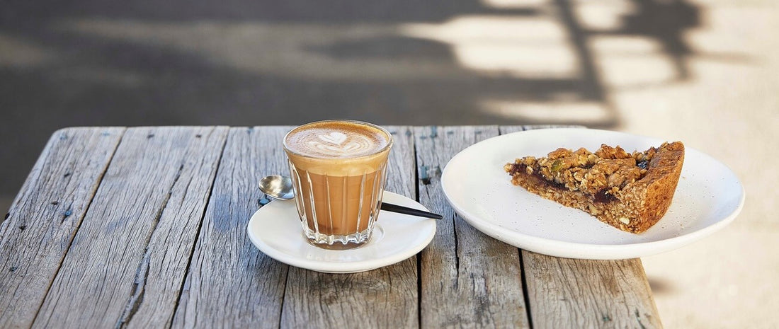Latte coffee with pasteries on a table