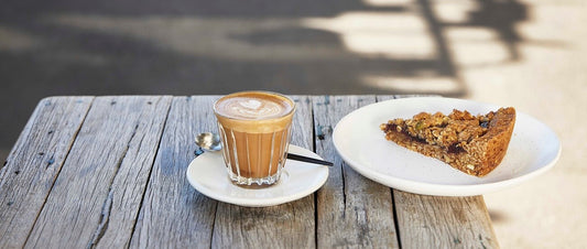 Latte coffee with pasteries on a table