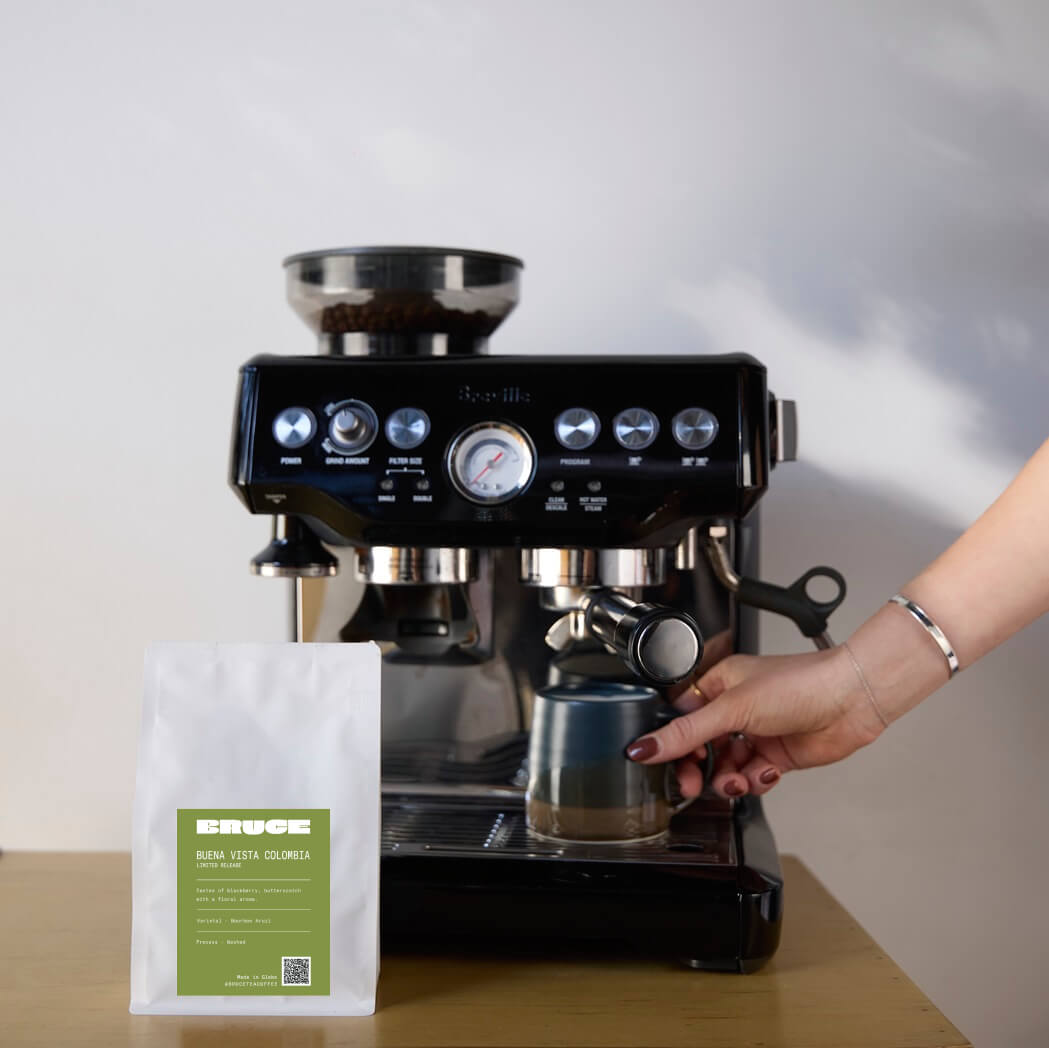 Bourbon Aruzi Coffee Beans bag next to espresso Breville coffee machine