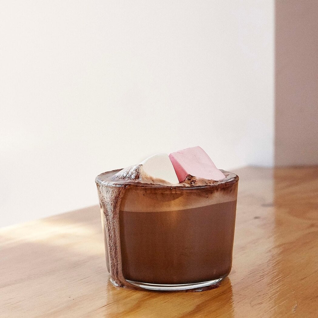 Sicilian Orange Grounded Pleasures drinking chocolate in a glass with marsh mallows.