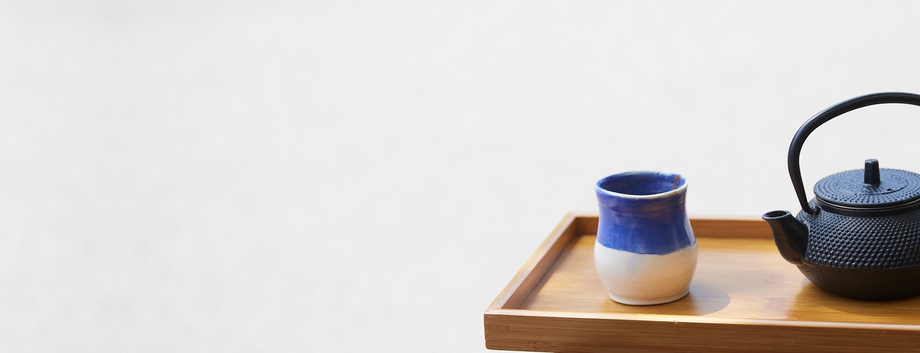 Tea cup and tea pot on a table