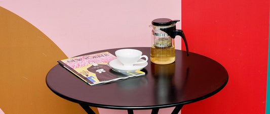 Tea cup on a table next to tea