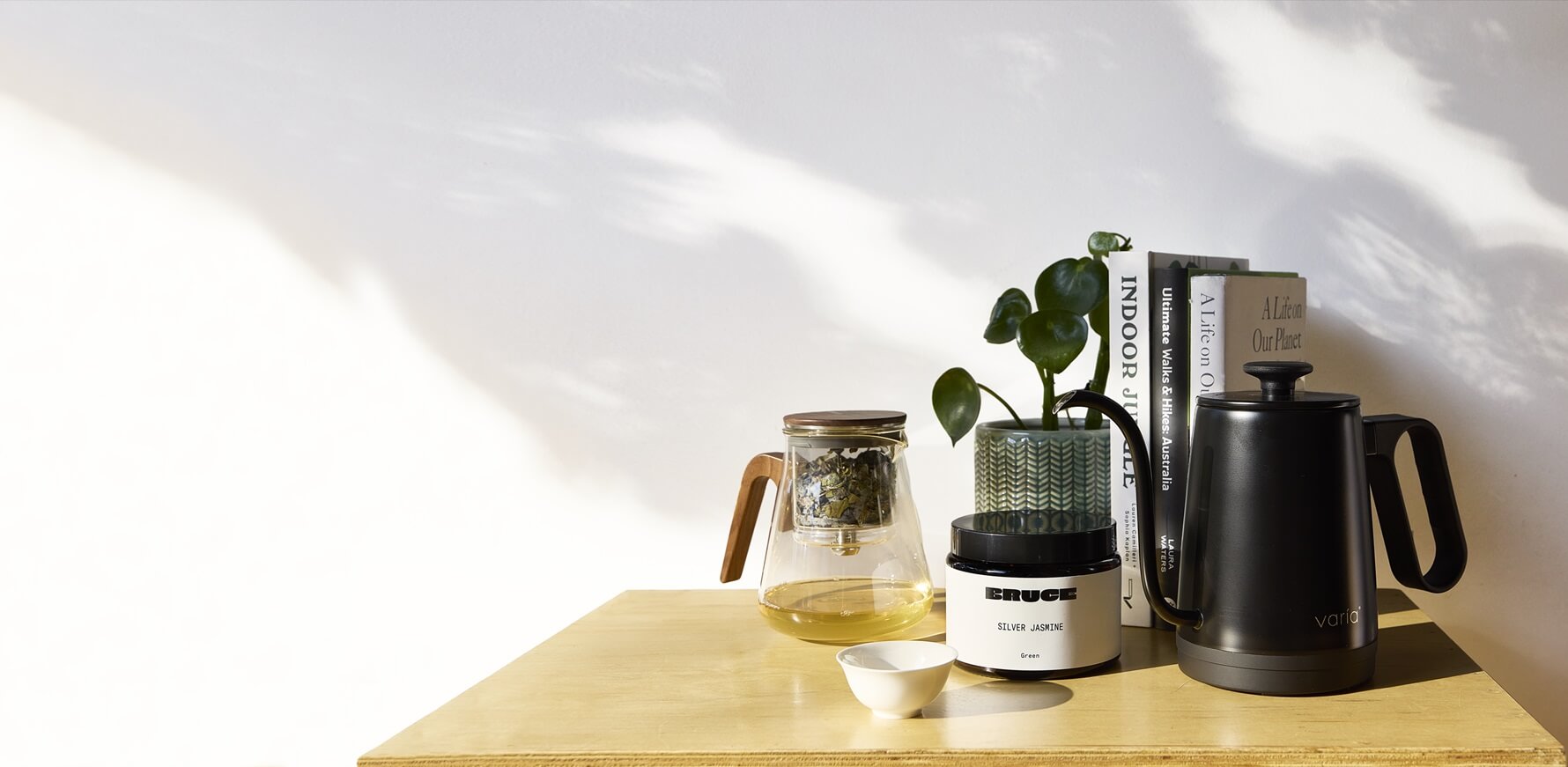 Loose leaf tea setup on a table next to books and kettle